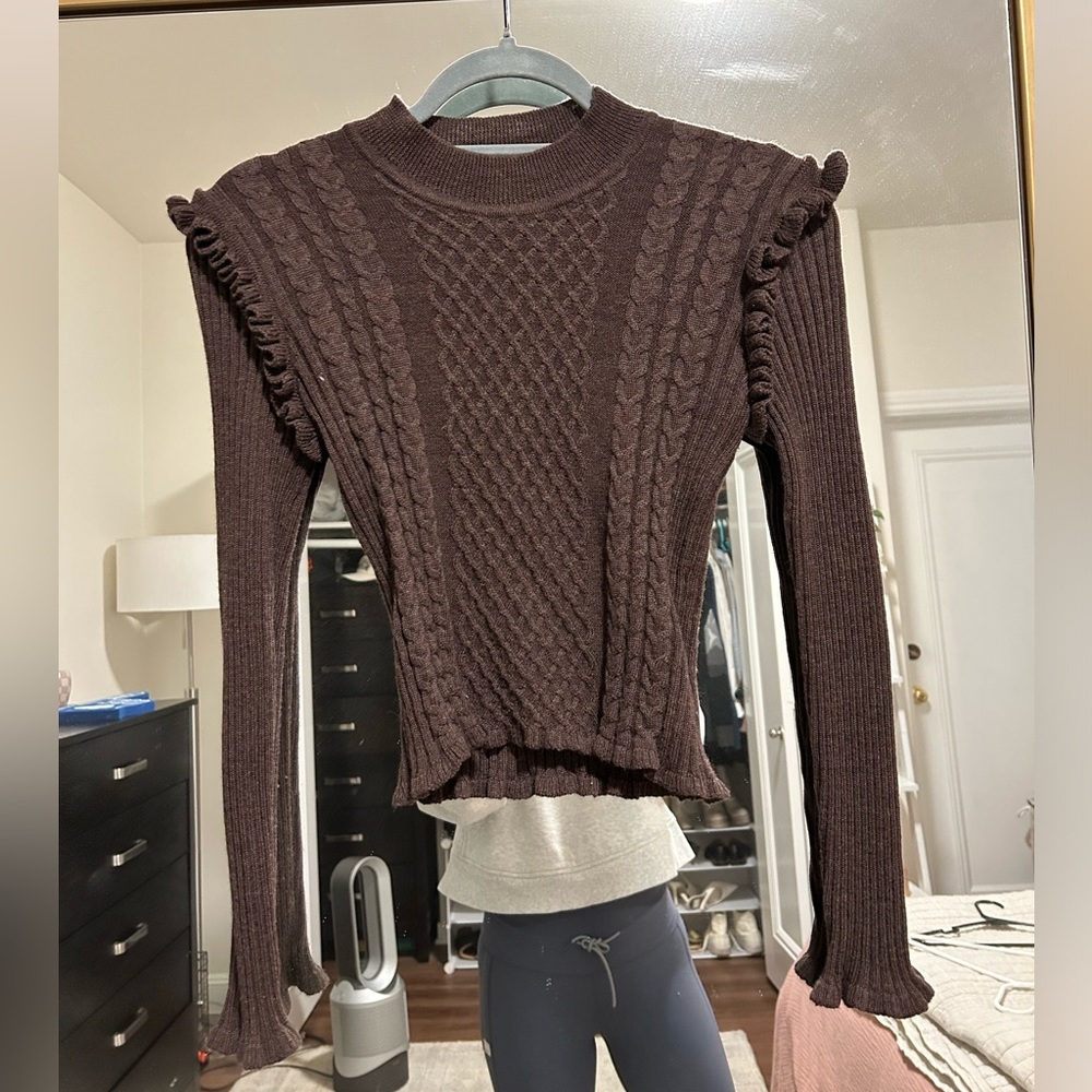 Knit sweater with ruffled shoulder detail